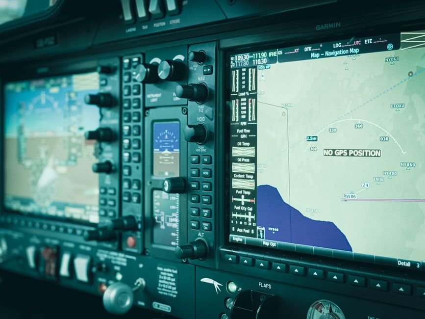 Detailed view of a modern aircraft cockpit display panel showcasing navigation systems and controls.